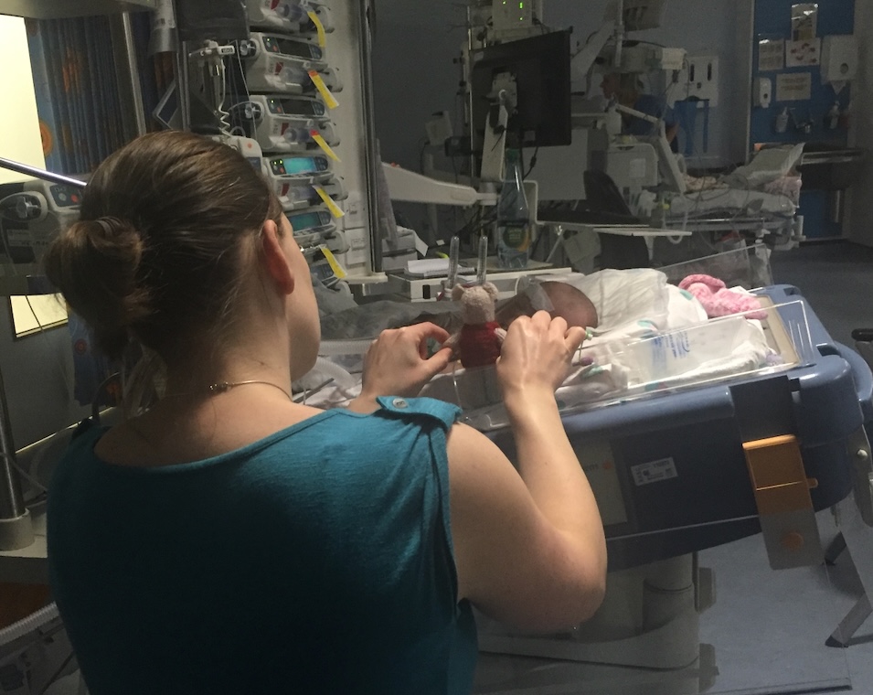 Sarah beside Sophie's cot in intensive care